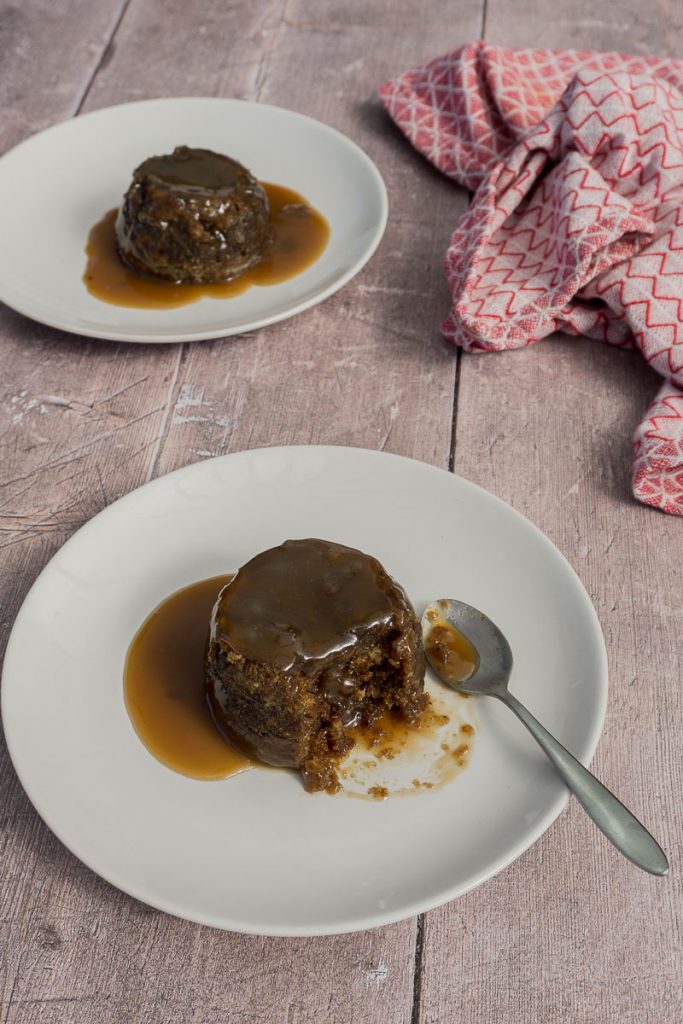 Microwave Sticky Toffee Pudding on a plate with tea towel