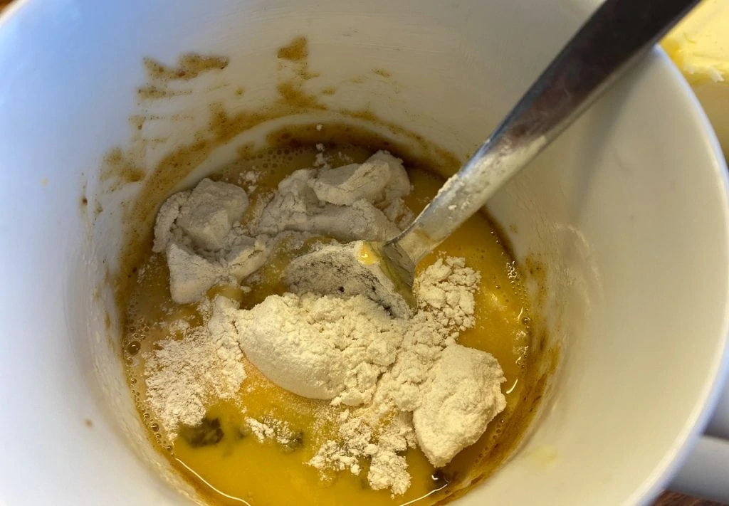 Flour and egg in mug for sticky toffee pudding in a mug