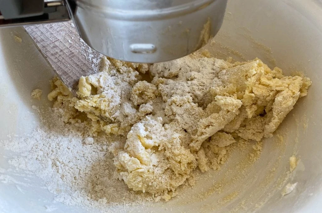 Adding flour to shortbread mixture