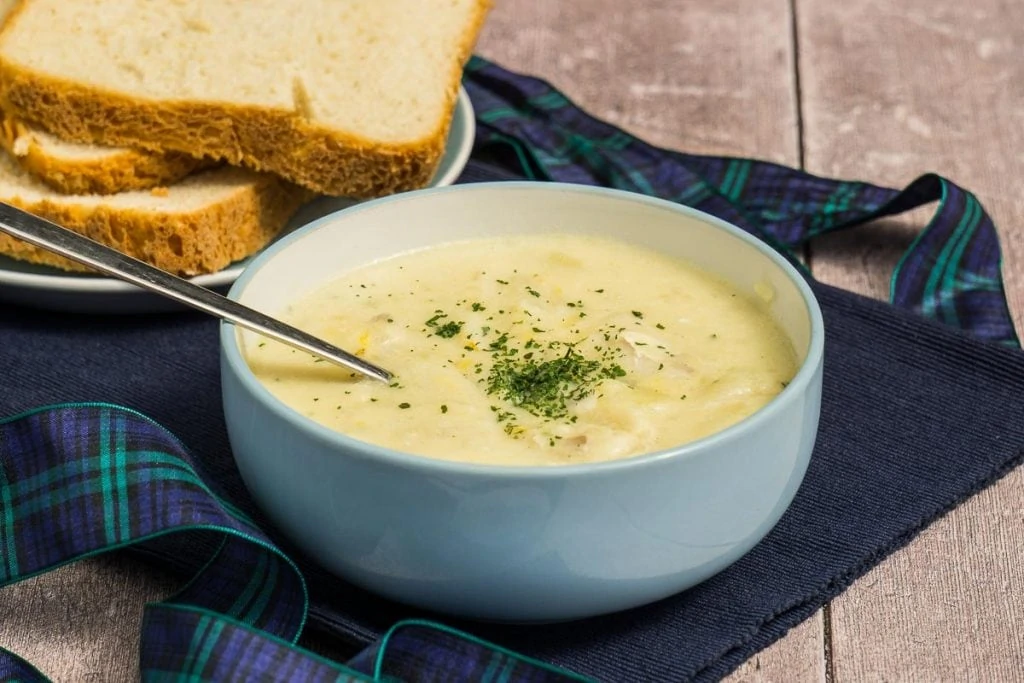 Cullen Skink Recipe - Cullen Skink in a bowl with spoon and crusty bread