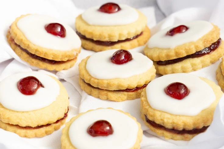 How to Make Empire Biscuits Recipe - Double Shortbread Biscuits sandwiched with jam, iced and topped with a cherry