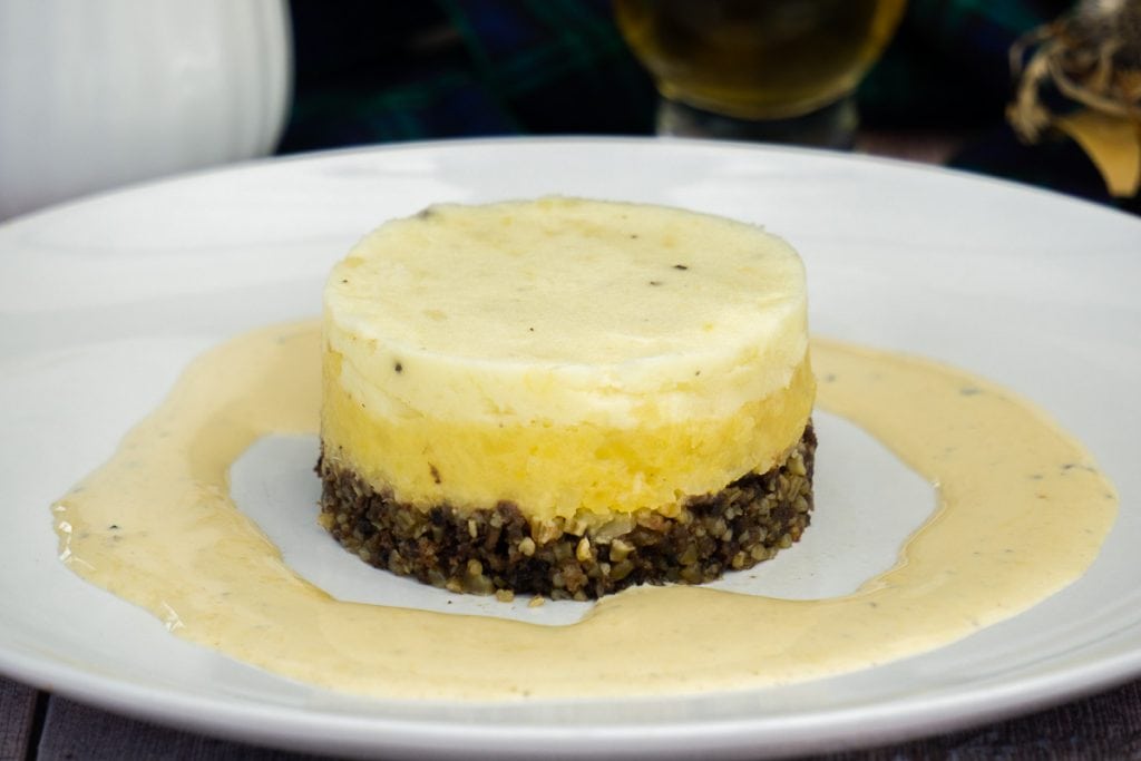 Haggis neeps and tatties and whisky sauce on a white plate