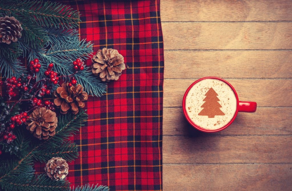 Cappuccino and pine branch with tartan on wooden table. - Scottish Christmas Food Menu Ideas