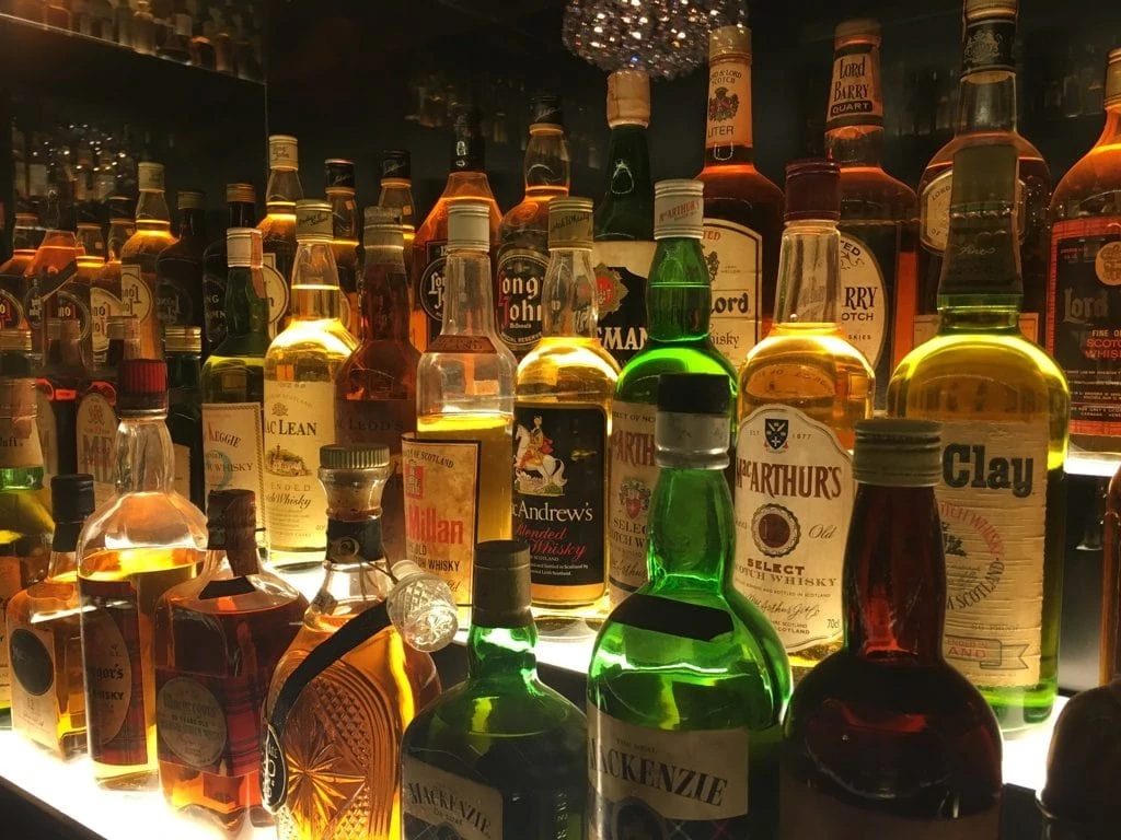 Bottles of Whisky lit behind glass at the Scotch Whisky Experience in Edinburgh