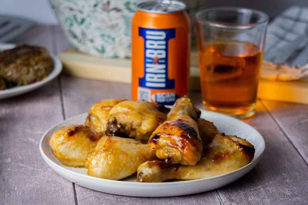 Irn Bru Glaze Recipe on Chicken with can and glass of Irn Bru in the background