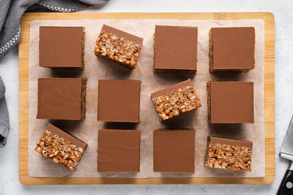 Mars Bar Traybake on a chopping board with some turned on their side to see the rice krispies
