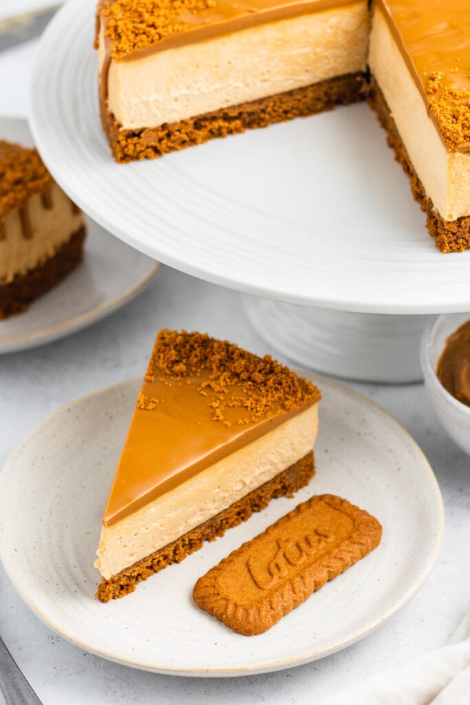 Lotus Biscoff Cheesecake Recipe - slice and whole cake on cake stand