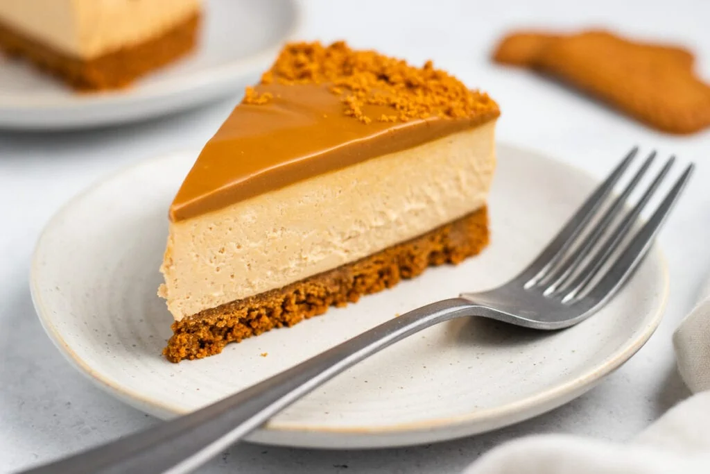 Lotus Biscoff Cheesecake Recipe - slice on a plate with a fork