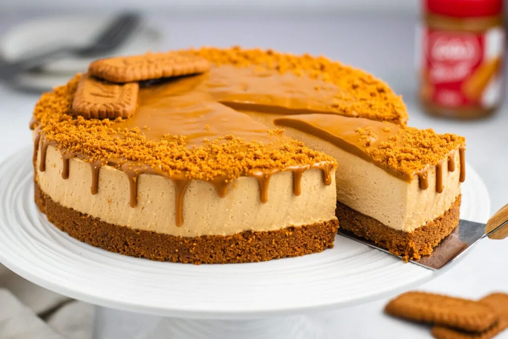 Lotus Biscoff Cheesecake Recipe - whole cake and one slice being taken out