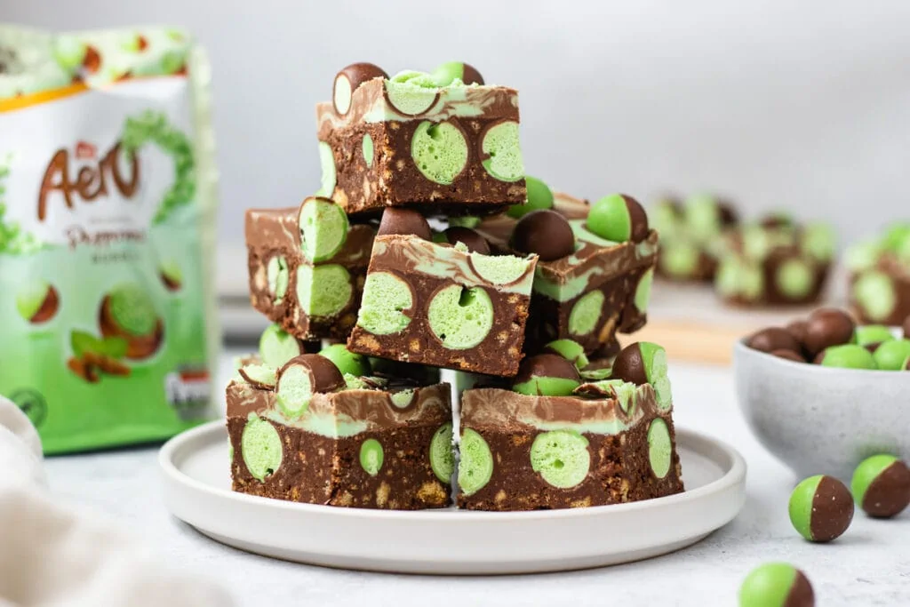 Mint Aero Traybake Slice Recipe - On a plate with mint aero bubbles and packet around