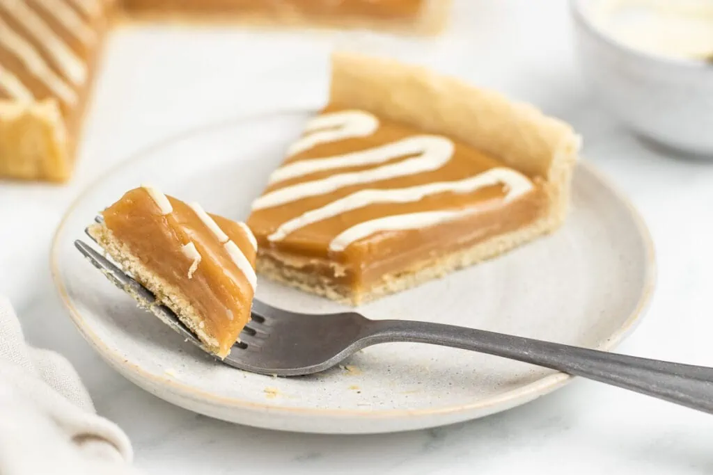 Butterscotch Tart Recipe slice on a plate with fork