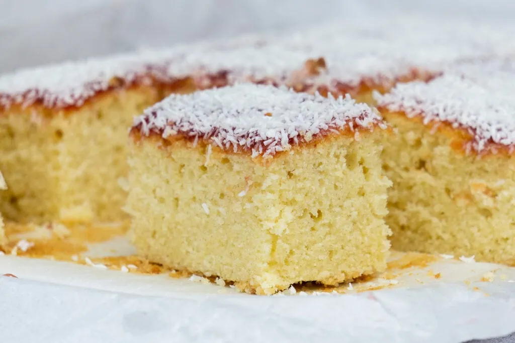 Jam and Coconut Sponge Traybake Recipe slice