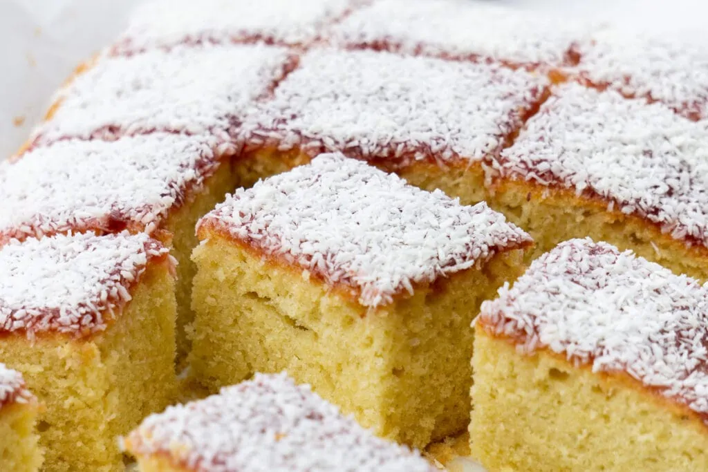 Jam and Coconut Sponge Traybake Recipe cut in slices