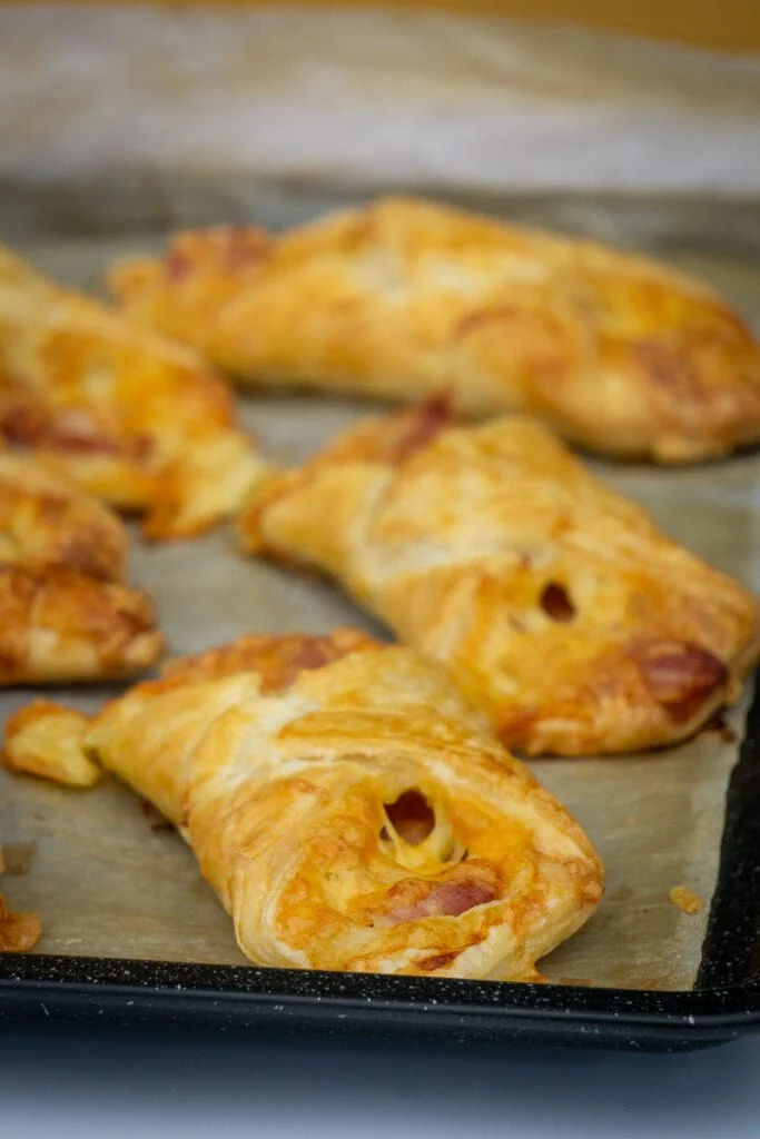 Cheese and bacon turnovers on a baking tray