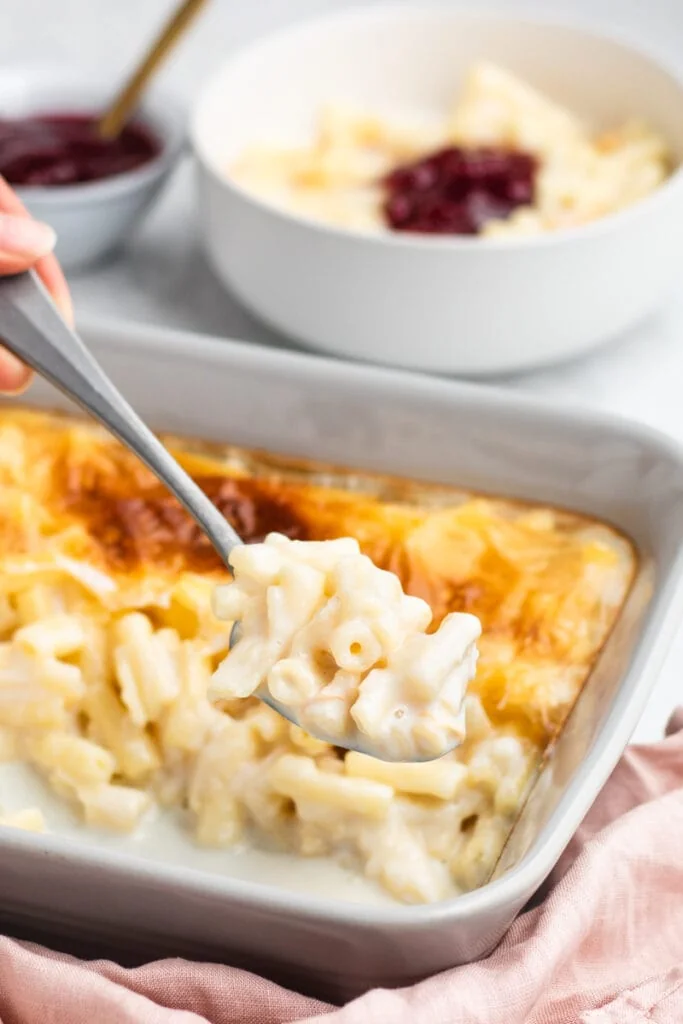 Macaroni Pudding Recipe - on a spoon with dish in the background