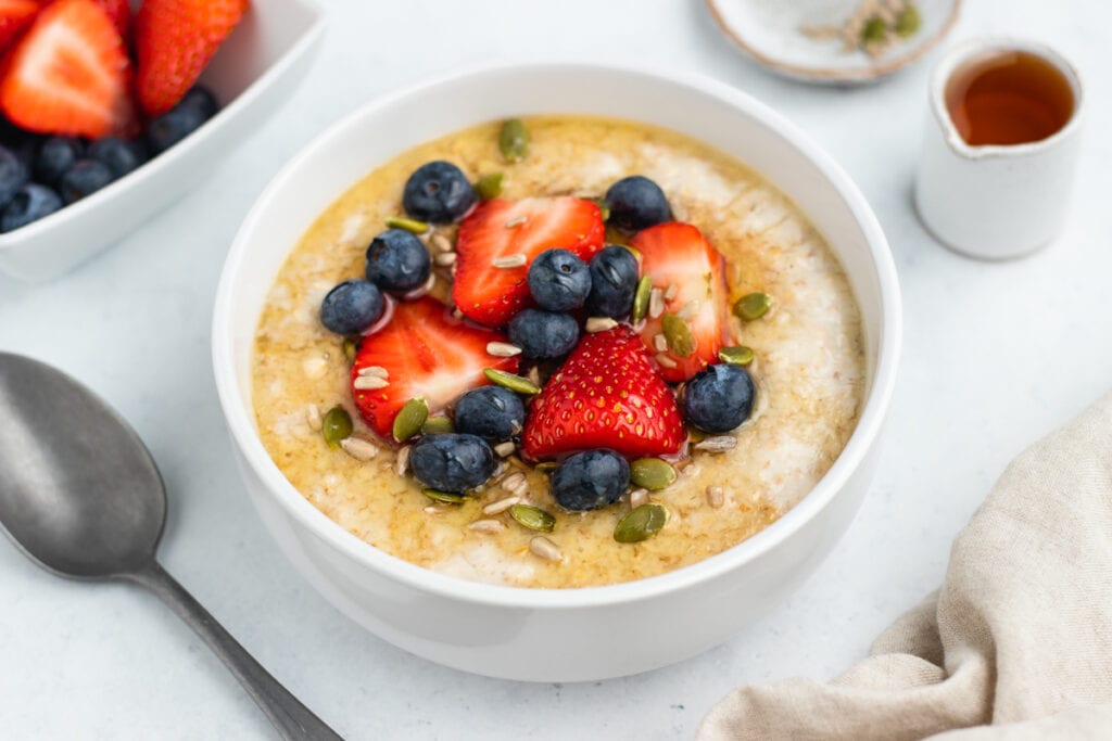 Porridge topped with fruit and seeds