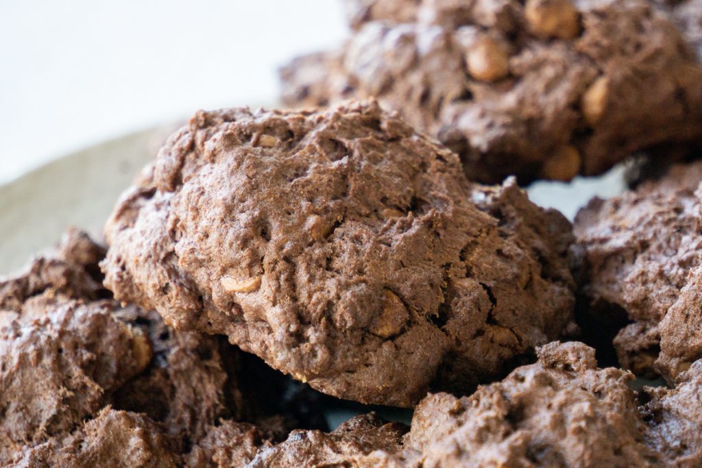 A close up of a chocolate rock cake, in a pile on a plate