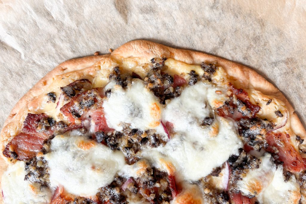 Close up of Haggis pizza with whisky sauce
