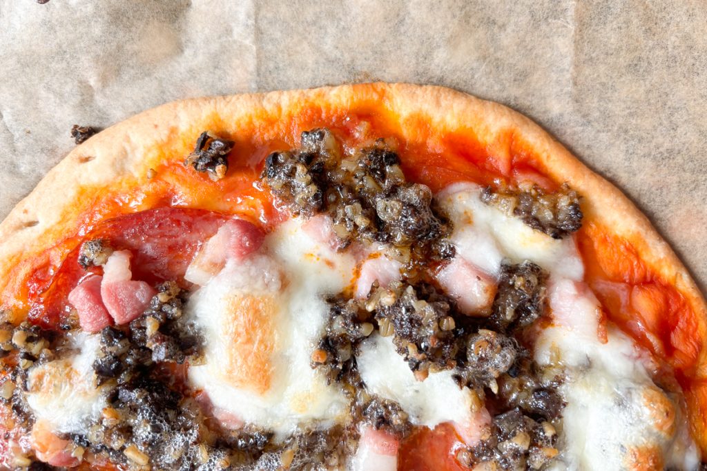 Close up of Haggis pizza with tomato sauce