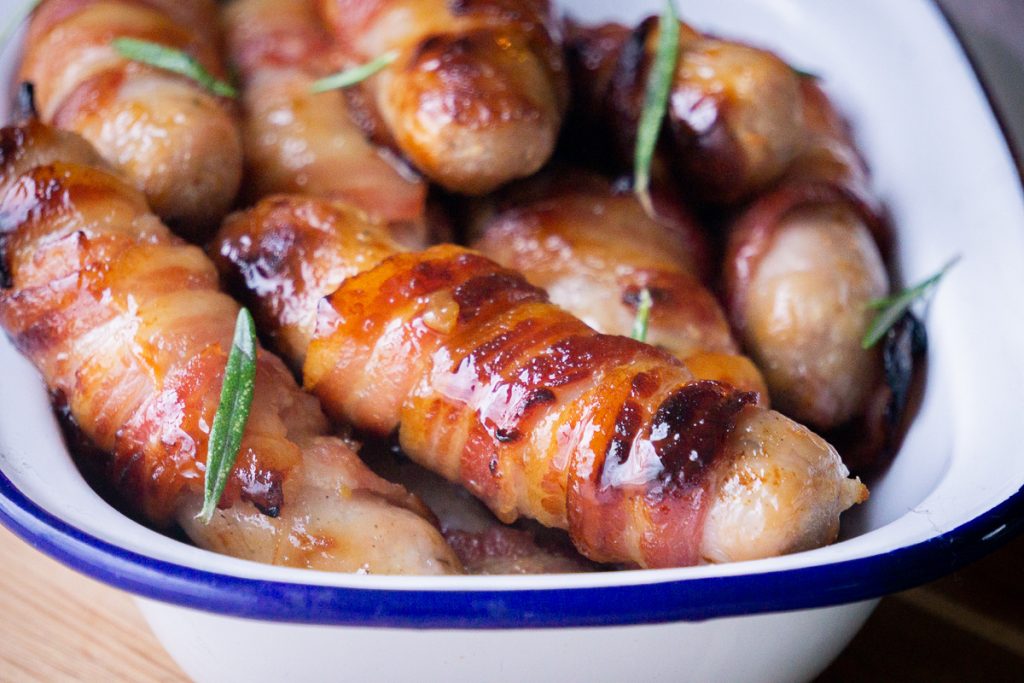 Close up of Kilted Soldiers/pigs in blankets with a glaze and rosemary