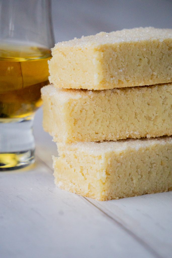 Classic Butter Shortbread Fingers Recipe - in a pile next to whisky